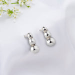 Load image into Gallery viewer, Silver earrings on a white background with delicate flowers.
